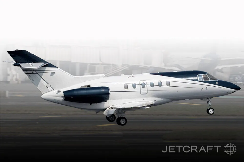 A white and dark blue business jet with fuselage-mounted engines is seen from the side, appearing to be on a runway.