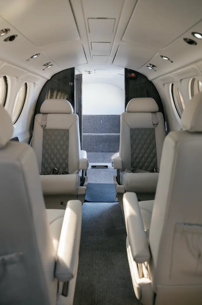 The interior of a King Air B200 aircraft, showing the seating arrangement.