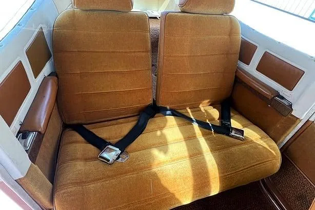 The brown and gold rear seats of a Cessna Cutlass RG II cabin.