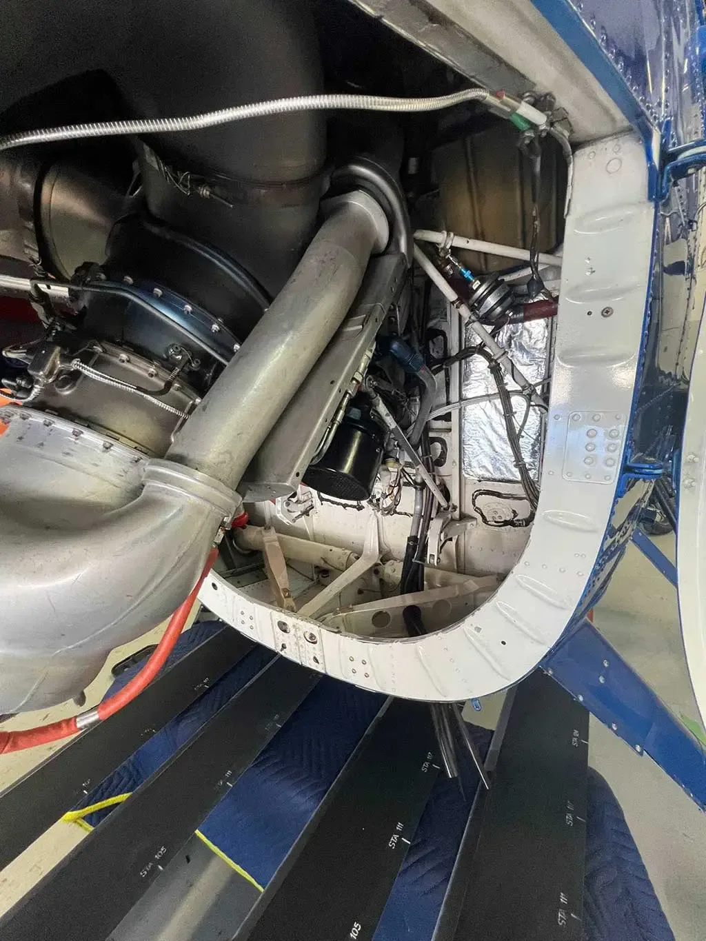 A detailed view of the helicopter's engine compartment, showing various mechanical components and piping.