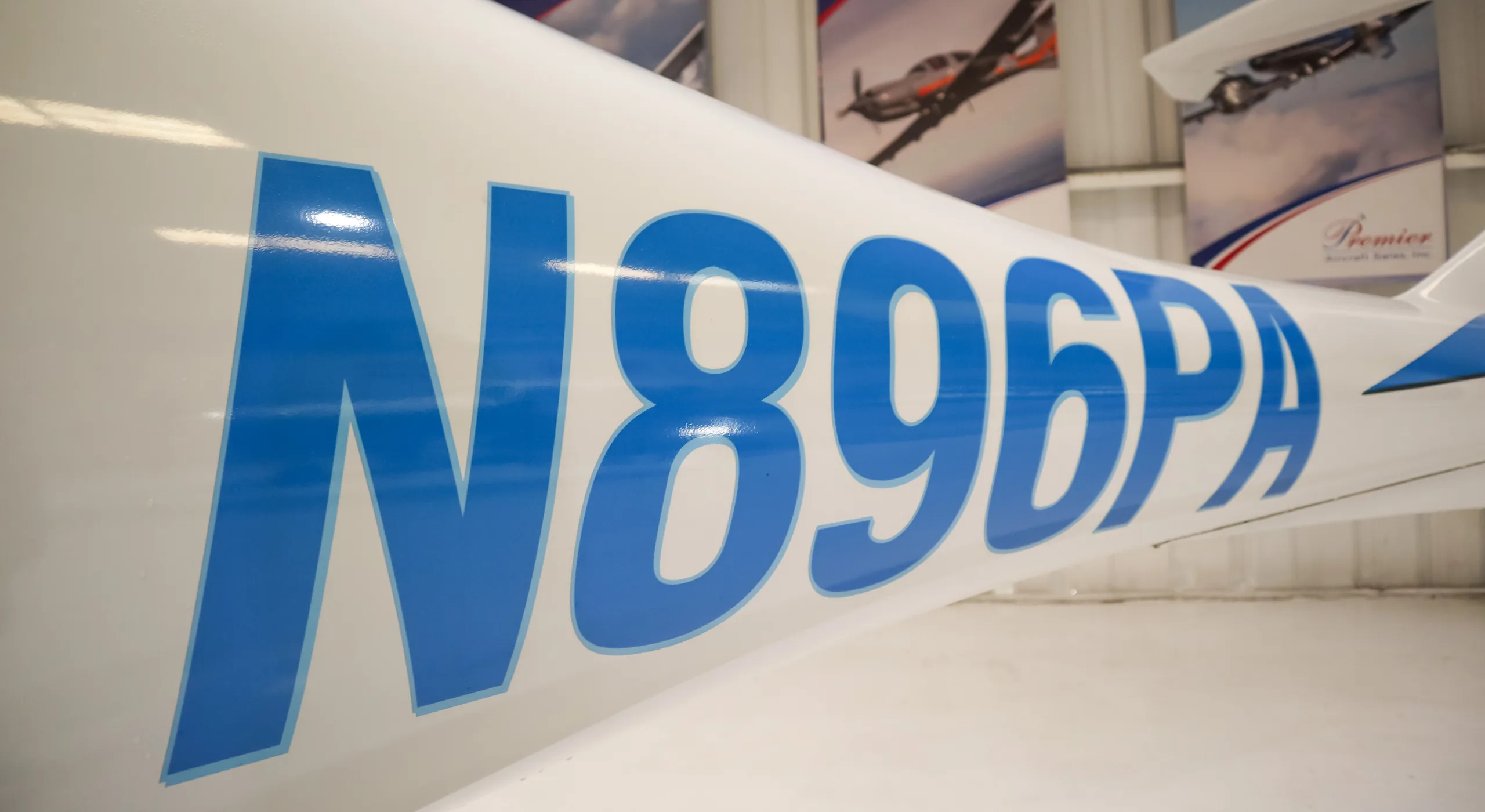 A close-up view of the blue N896PA registration on the white fuselage of a Diamond DA40 aircraft.