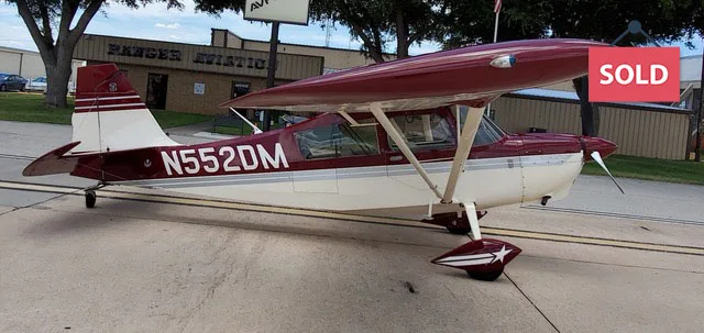 Side view of a light aircraft with the registration number N552DM on the fuselage.