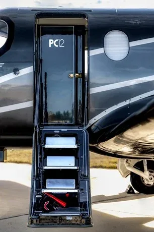 Close-up of the Pilatus PC-12 aircraft door and steps.