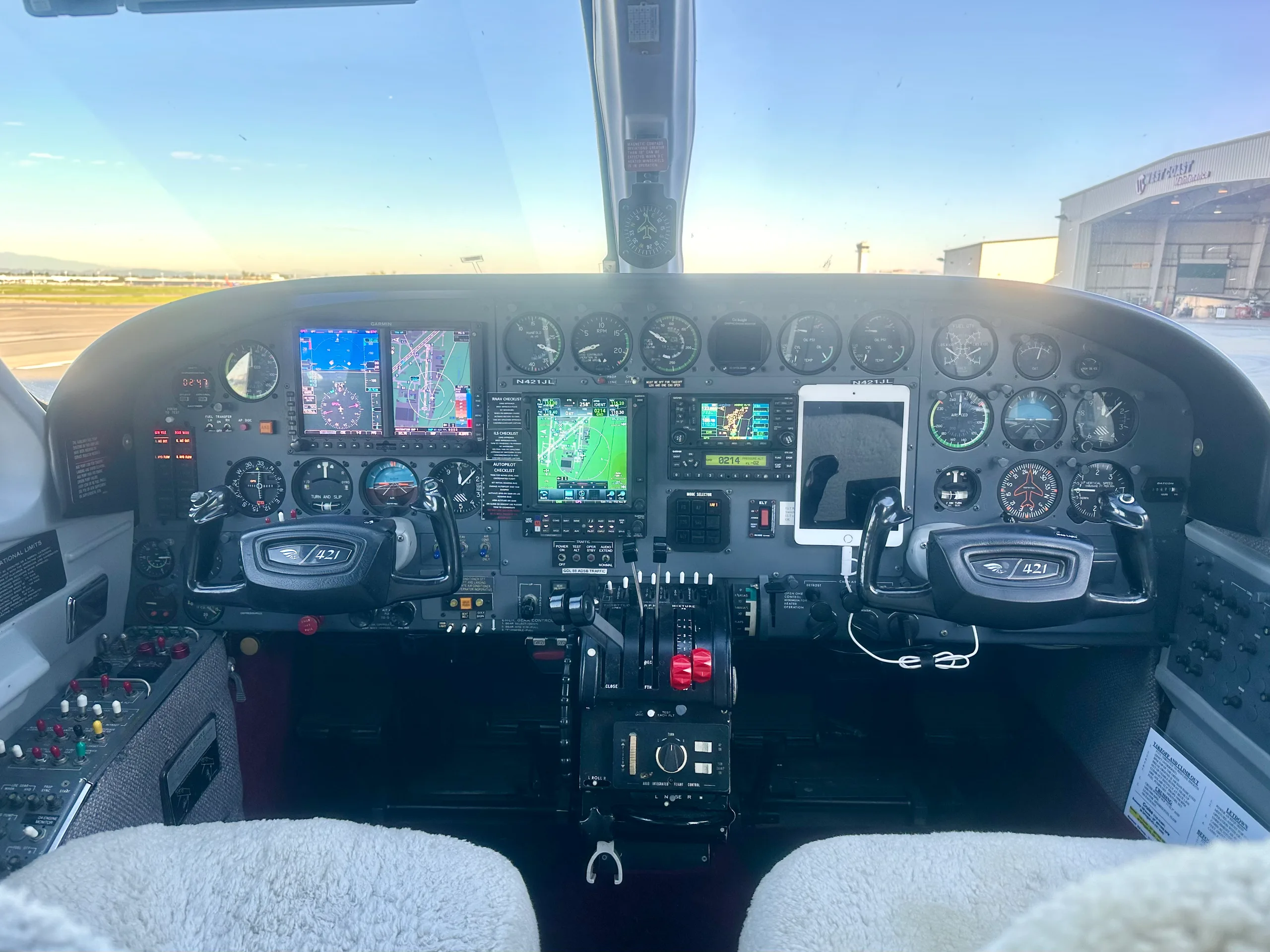 The cockpit of a Cessna 421 Golden Eagle II, showing the instrument panel with analog gauges and modern digital displays.