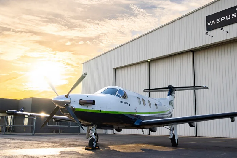 Pilatus PC-12 aircraft N861PP parked in front of a hangar at sunset.