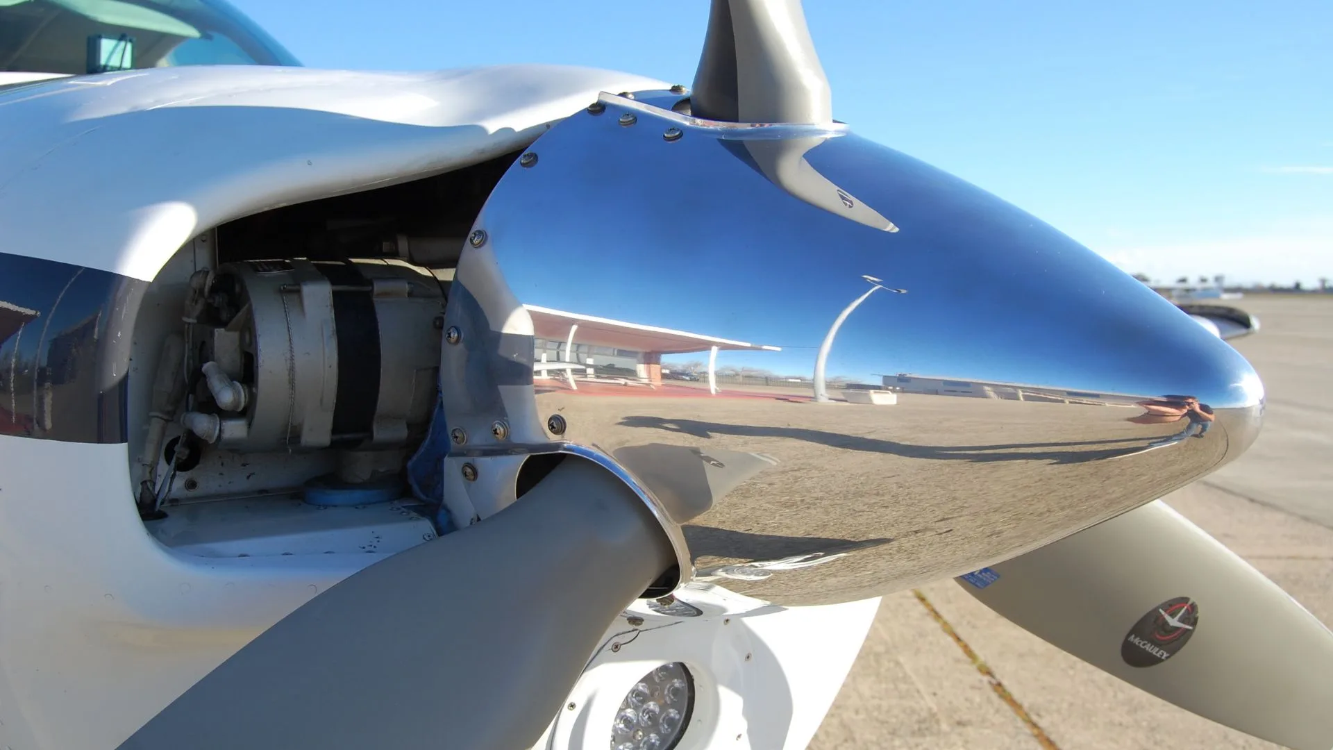 Close-up of the propeller and engine cowling of a Beechcraft Bonanza.