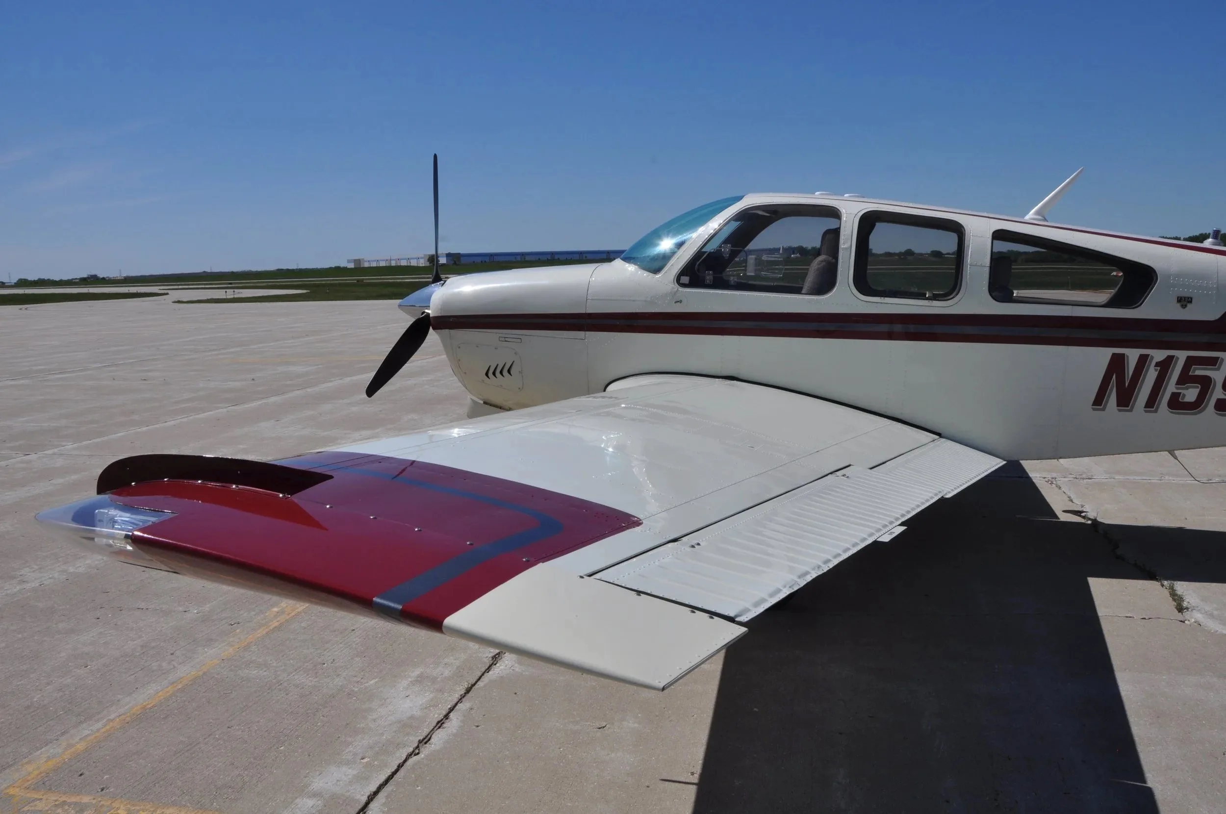 A view of the right wing and fuselage of the Beechcraft Bonanza F33A N159GM on the tarmac.