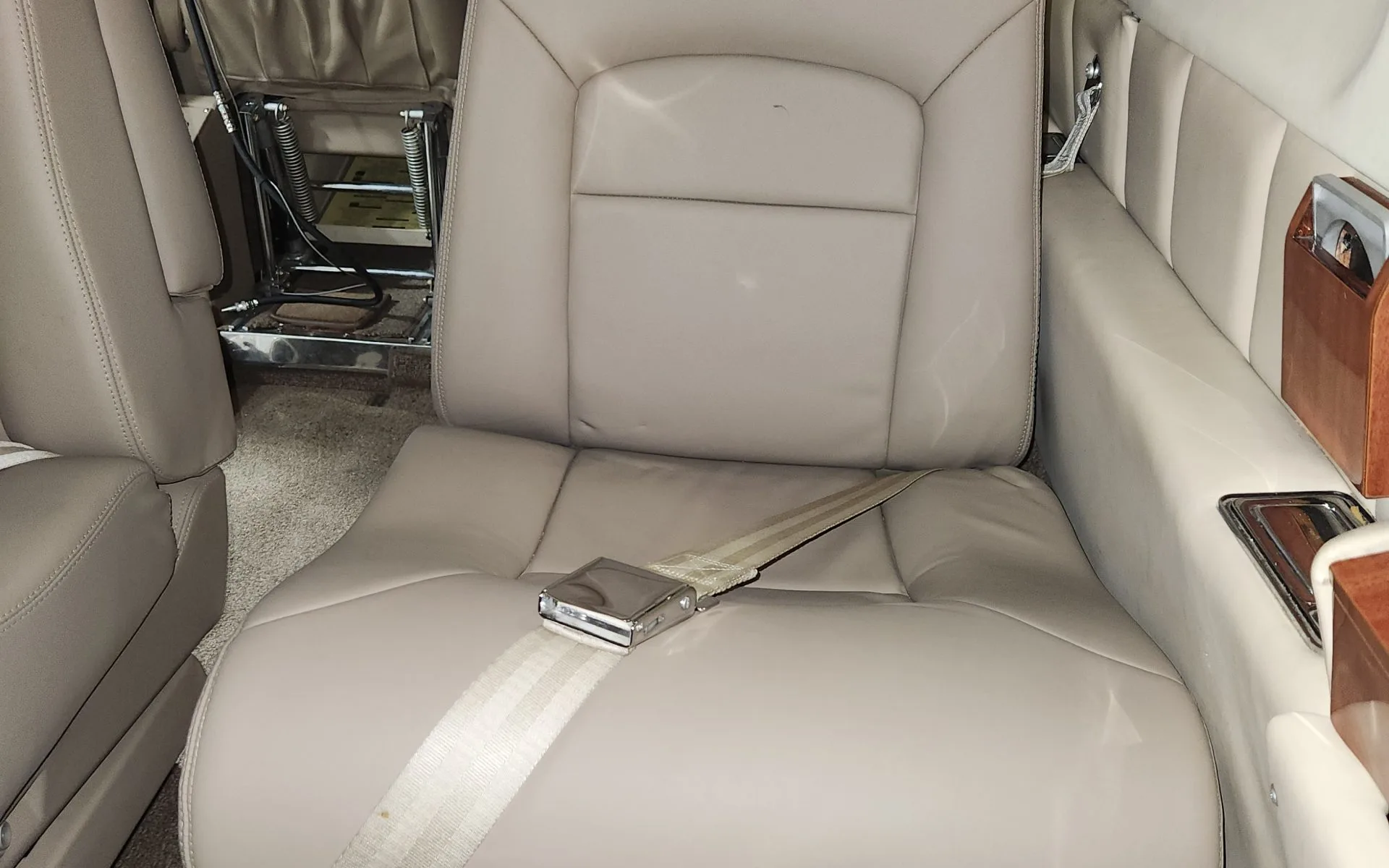 Close up of a tan leather seat in the Commando aircraft.