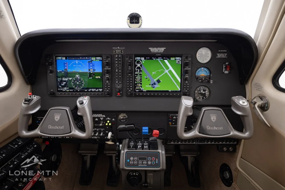 The cockpit of a Beechcraft Bonanza G36, featuring two large Garmin G1000 displays and dual yokes.