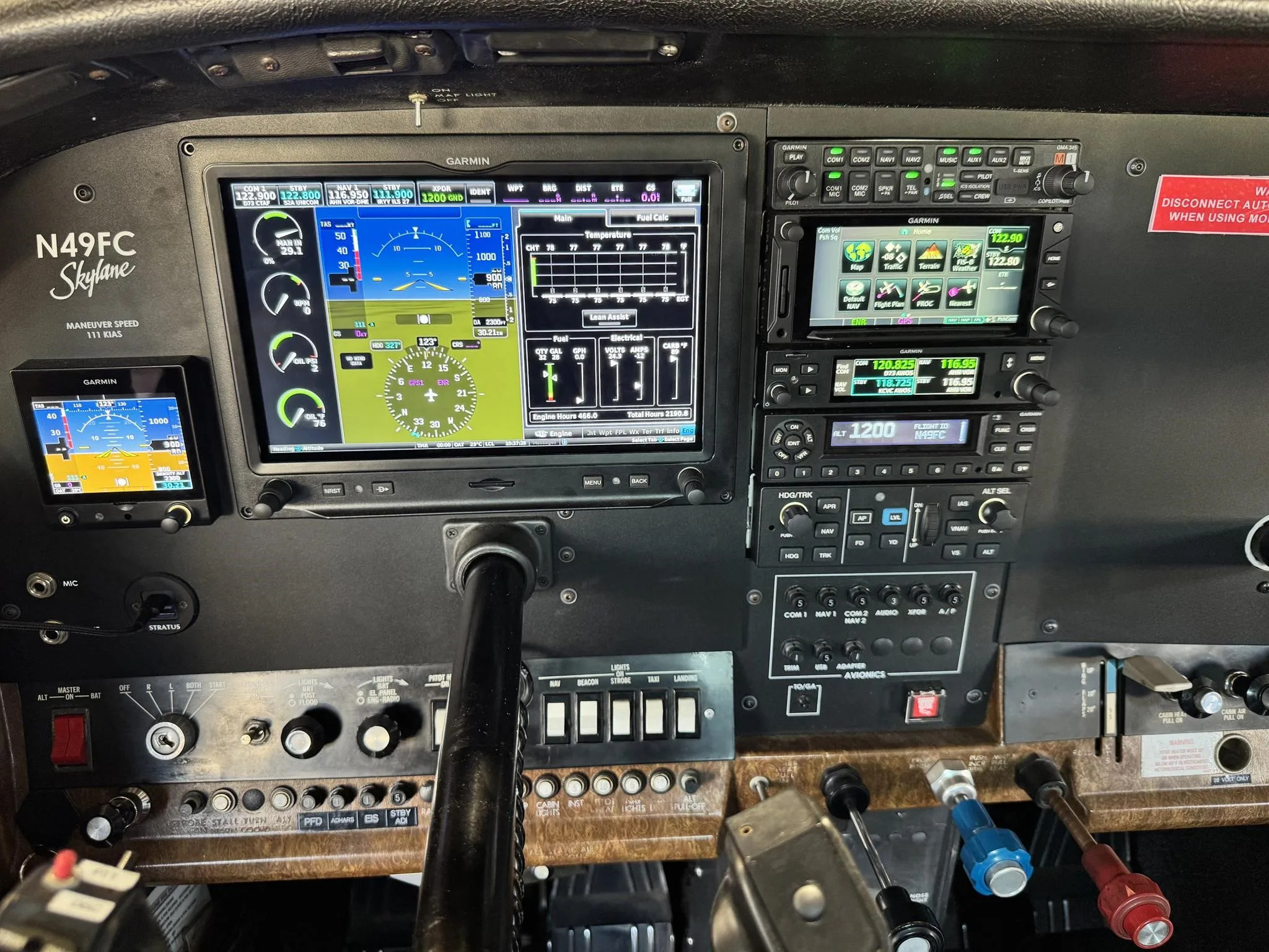 The cockpit of the Cessna N49FC, featuring modern Garmin avionics displays and traditional controls.