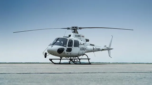 A white single-engine helicopter, registration B-7440, viewed from the front-right on an asphalt runway.