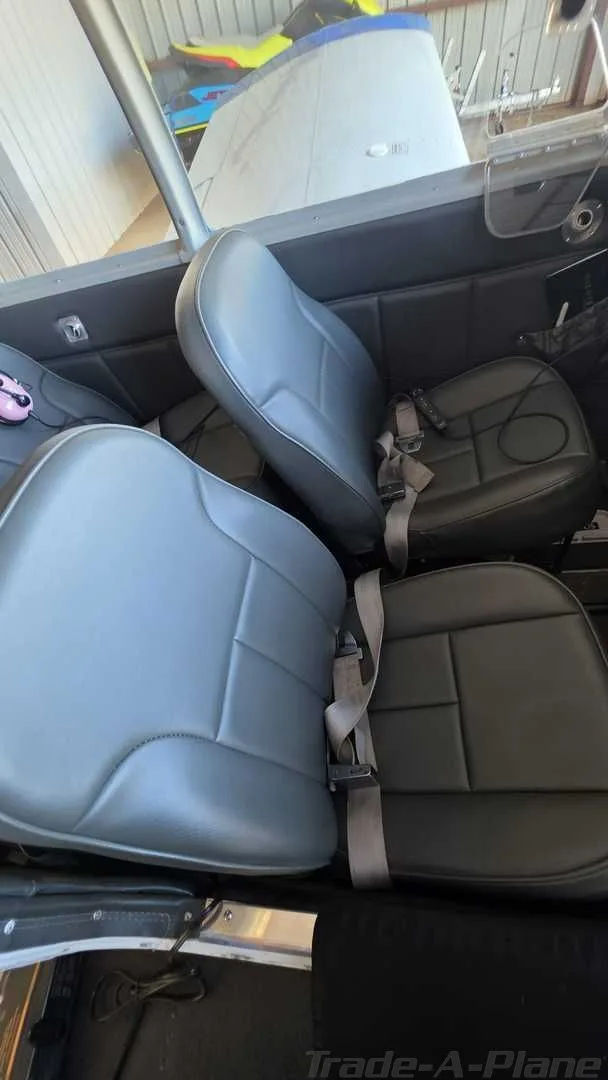 The gray and black upholstered seats of the aircraft cabin.