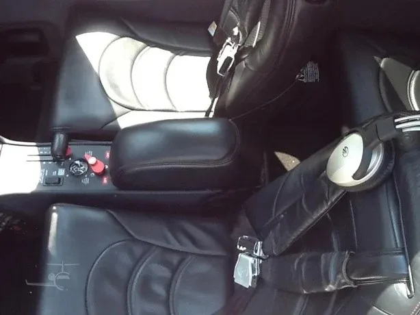 The black leather interior seats and center console of a Cirrus SR22T aircraft cabin.