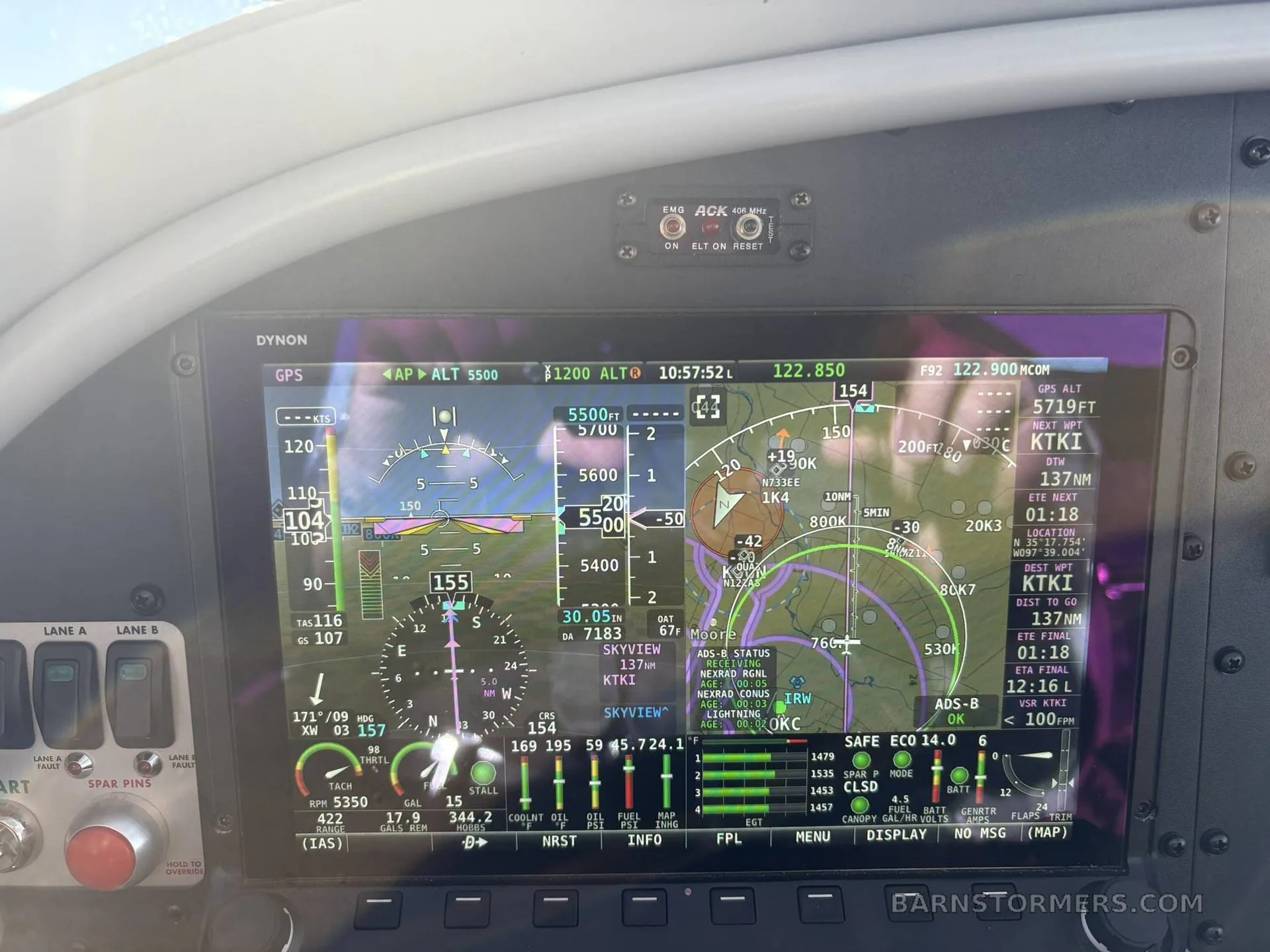 A Dynon avionics display in a cockpit, showing flight instruments, GPS map, and engine parameters.