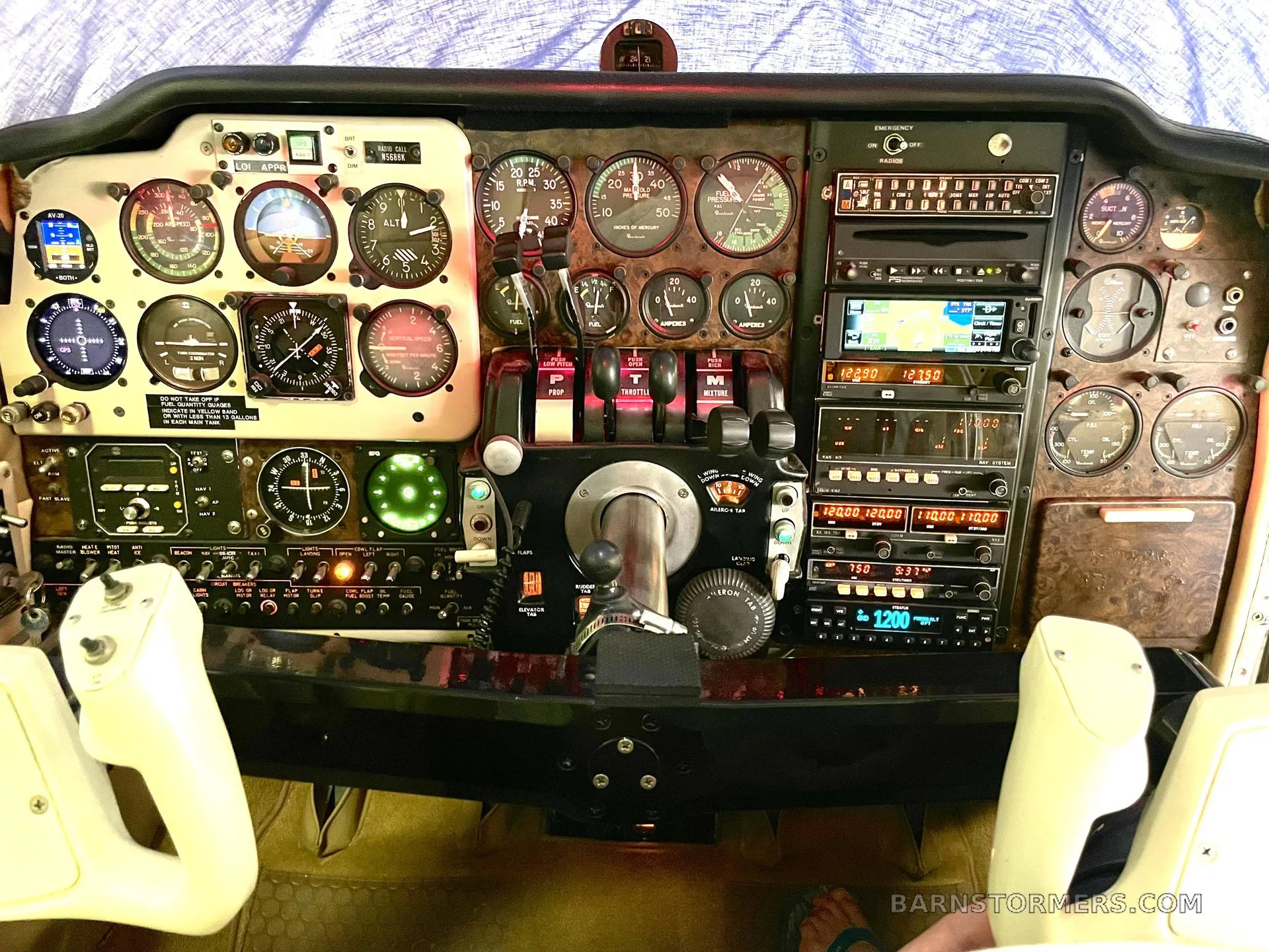 The detailed instrument panel and controls of a twin-engine aircraft, featuring analog gauges and digital displays.