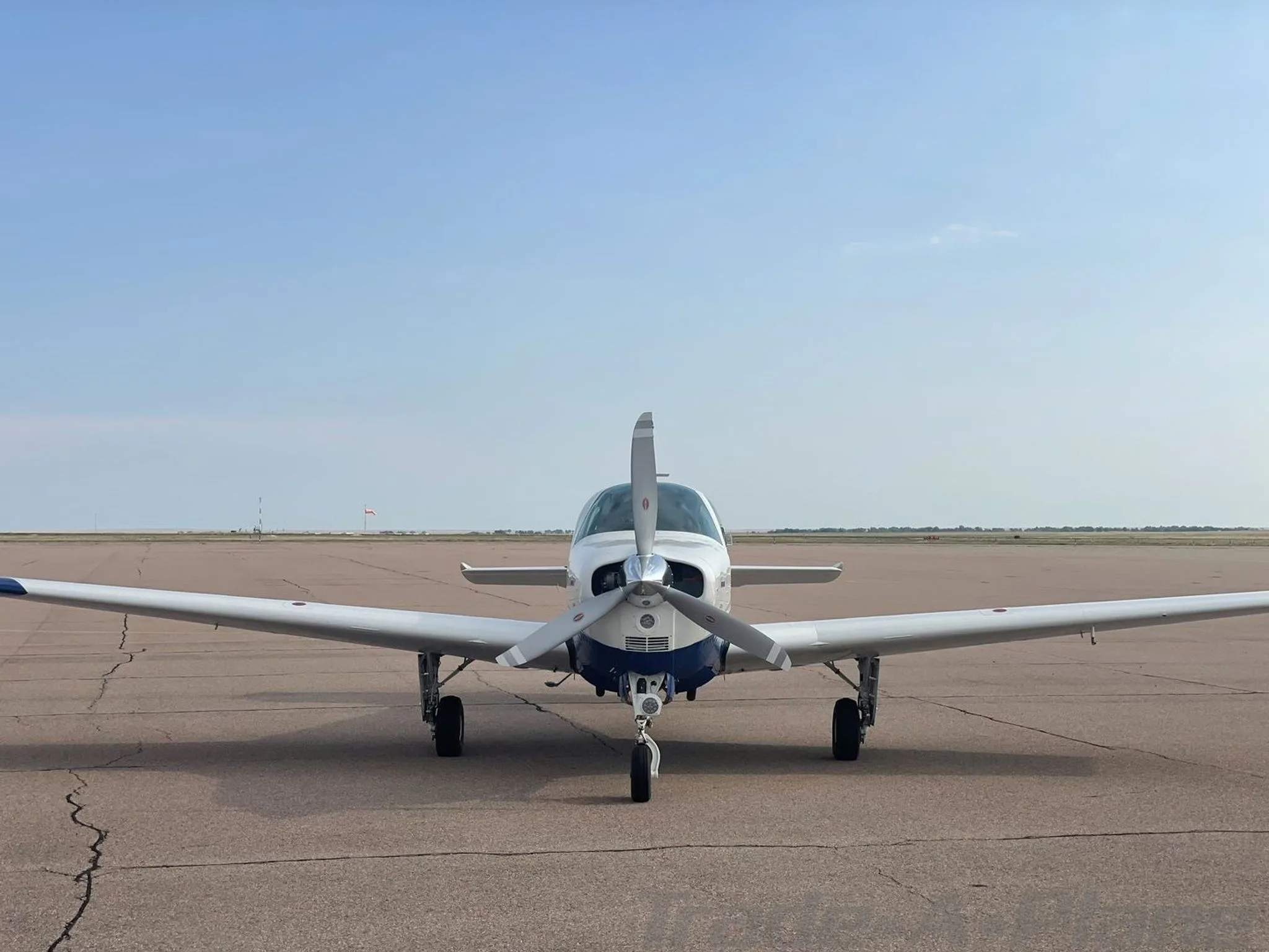 Front view of the Beechcraft 33 Bonanza on the runway.