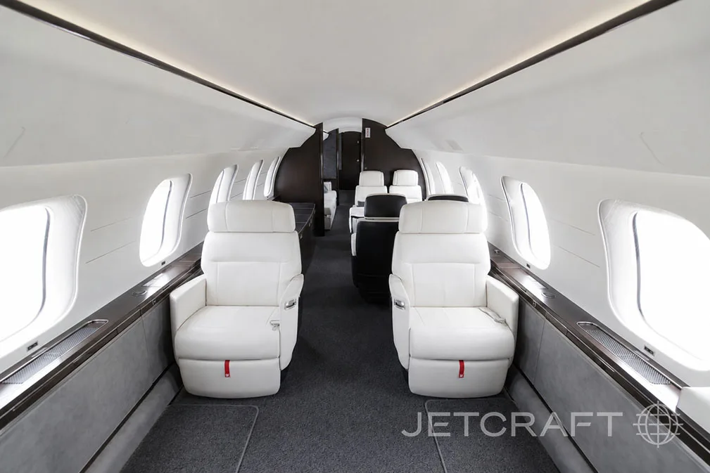 The luxurious white and dark grey cabin interior of a Bombardier Global 7500 with two forward-facing seats.