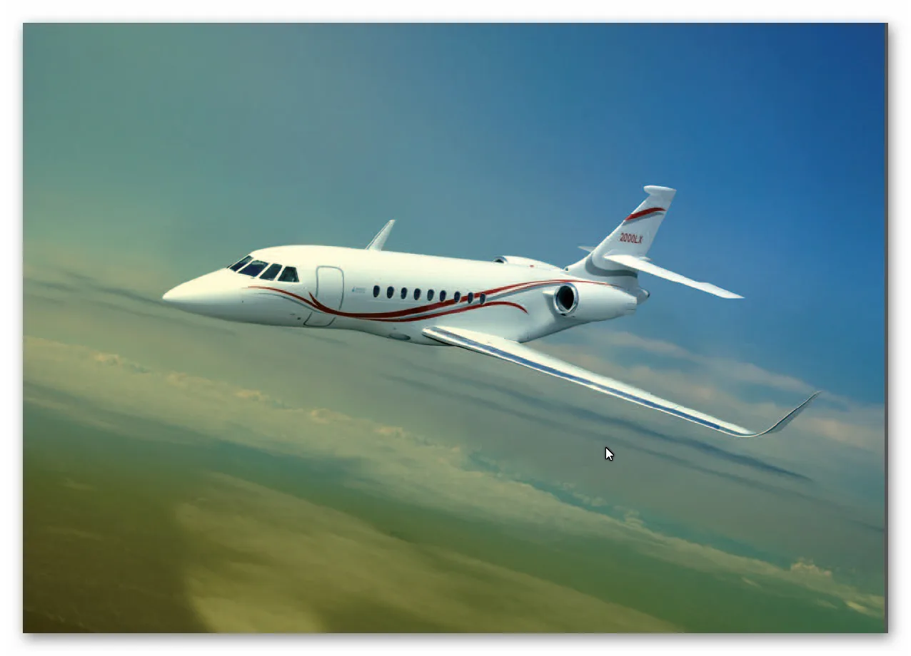 A white Dassault Falcon 2000LX private jet with red accent stripes flies against a blue and green sky.