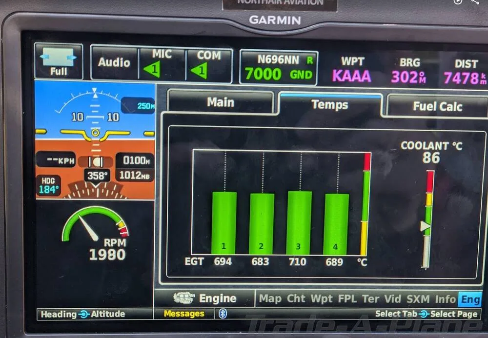 A close-up of a Garmin display in the cockpit, showing engine temperature and RPM data for N696NN.