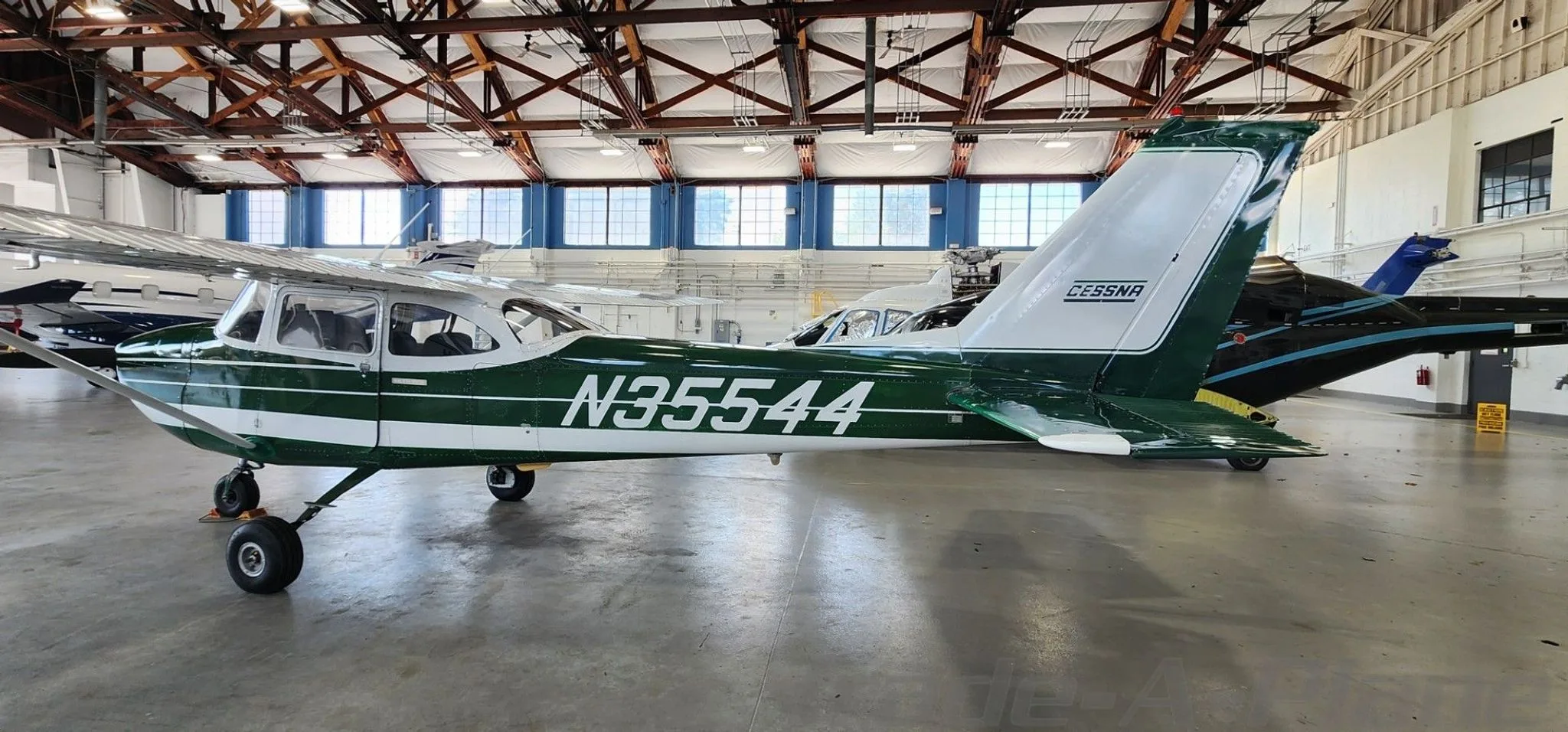 A side view of the Cessna 172 in a hangar.