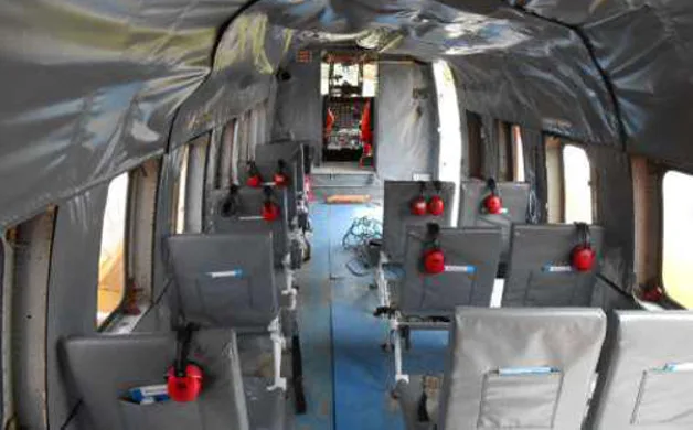The interior cabin of a Sikorsky S-61 helicopter with seats.