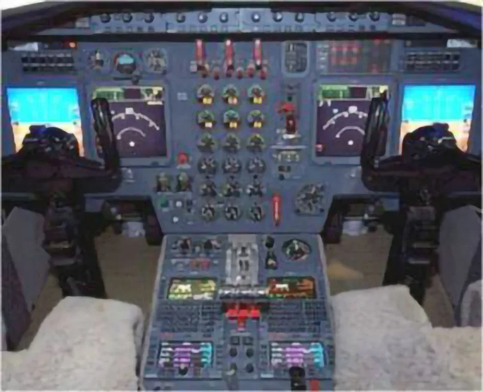 The cockpit of a private jet featuring multiple digital displays and control panels.