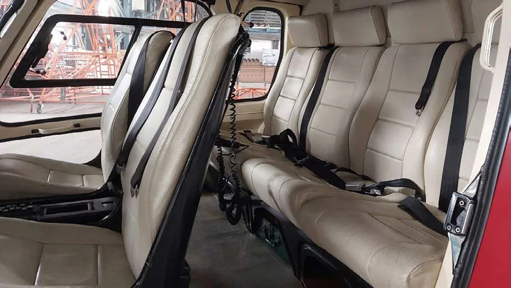 A view of the light beige passenger seats in the helicopter's cabin.