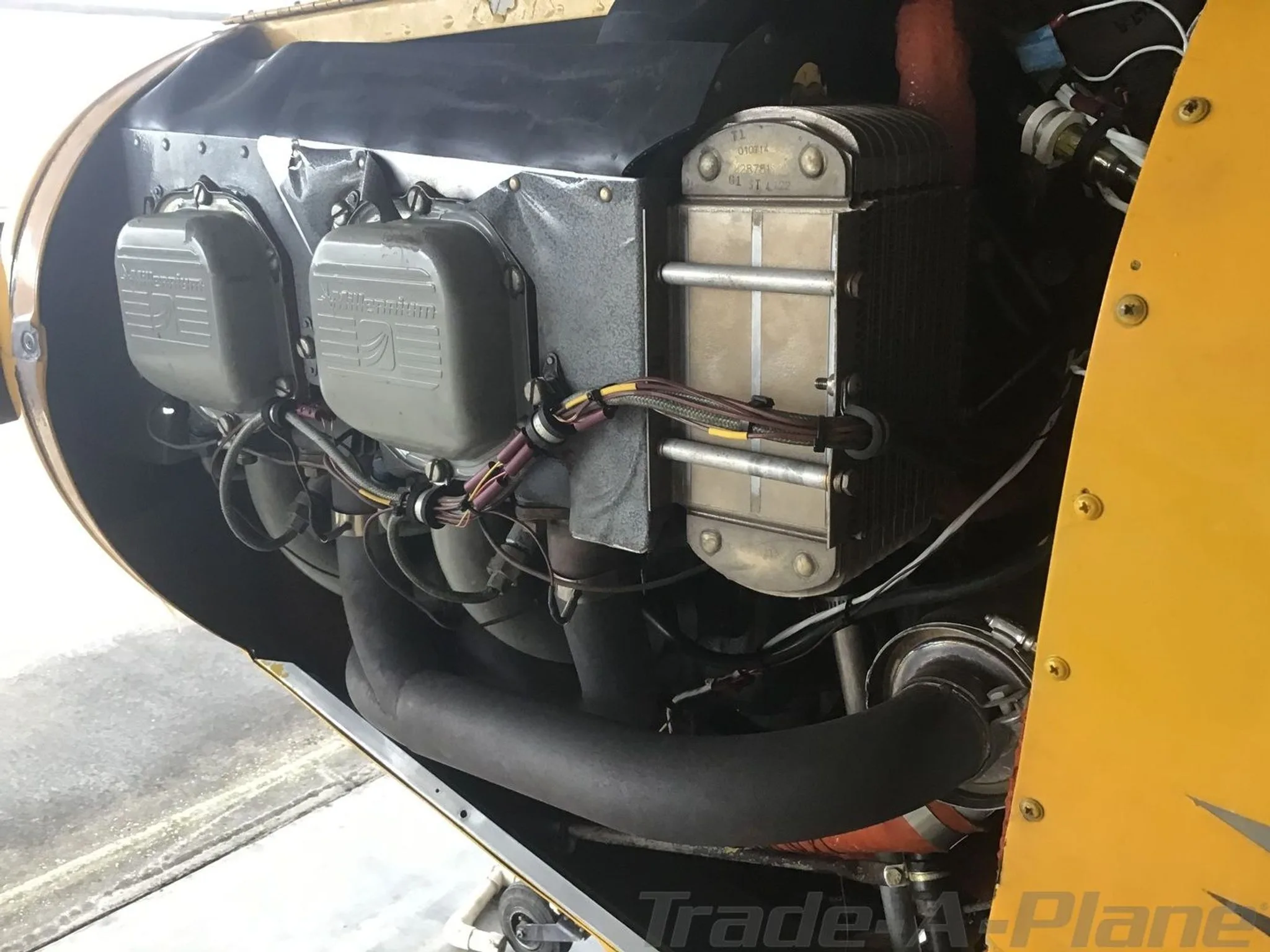 Close-up view of the aircraft's engine compartment showing cylinders and exhaust pipes.