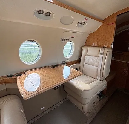 Close-up of a seat and table in the cabin.