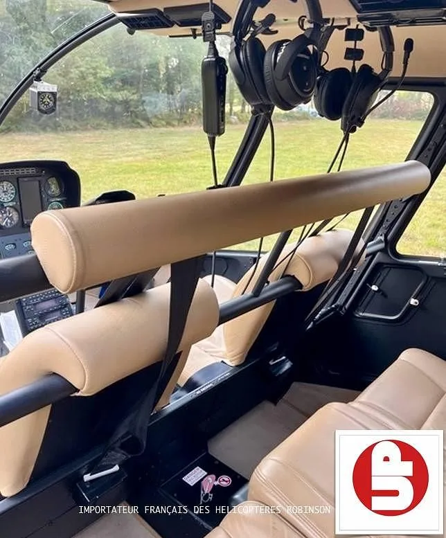 The tan leather front seats and overhead structure inside the helicopter cabin.
