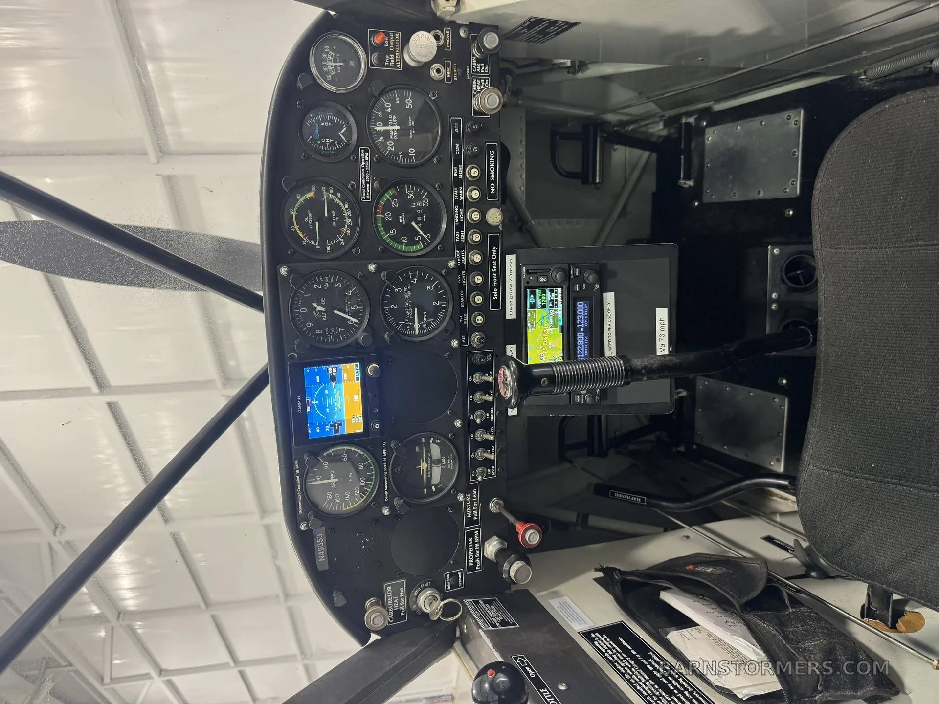 The cockpit of an Aviat Husky A-1 features analog gauges and two digital displays.