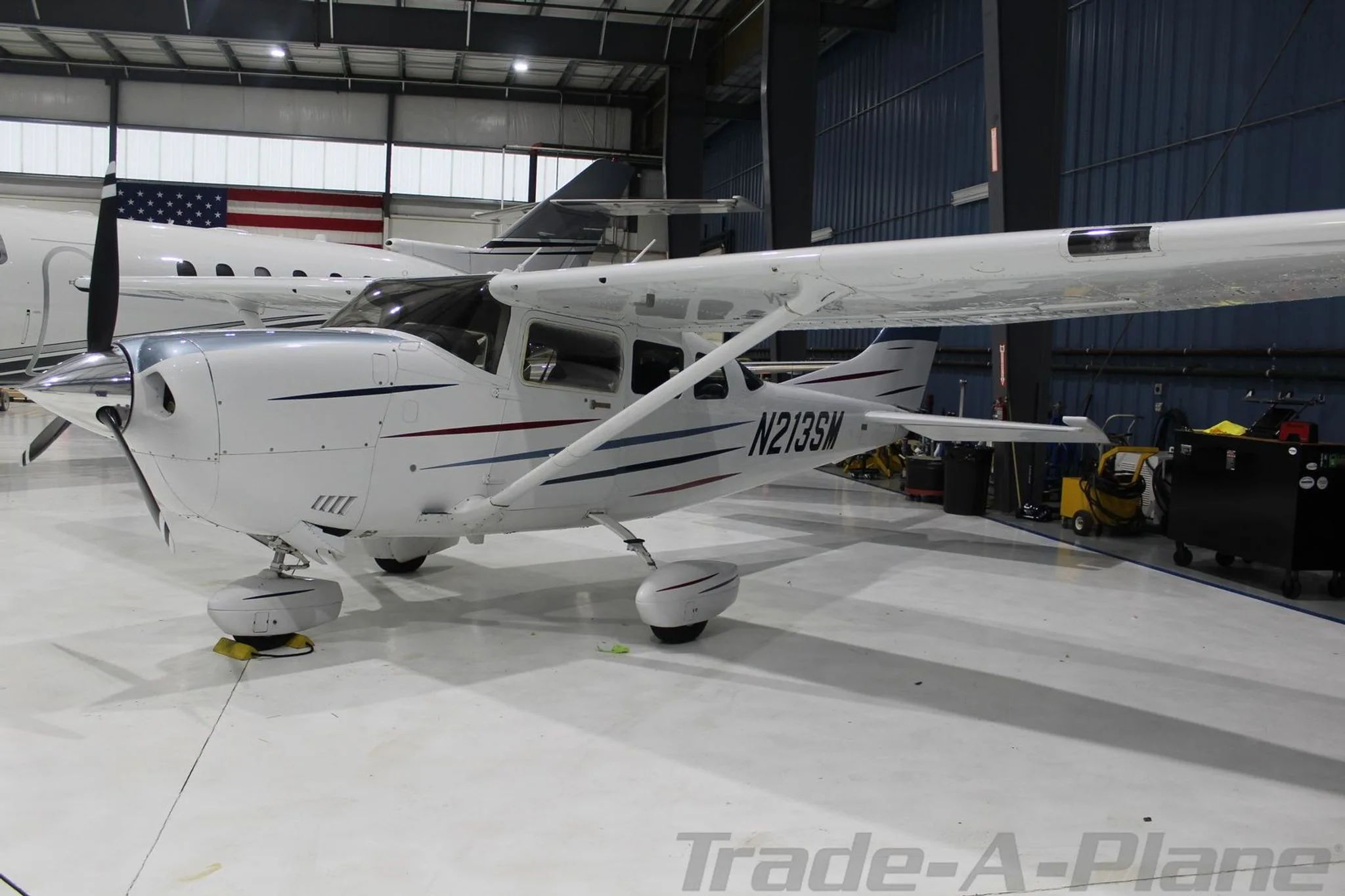 Another view of the Cessna 206H Stationair inside a hangar.