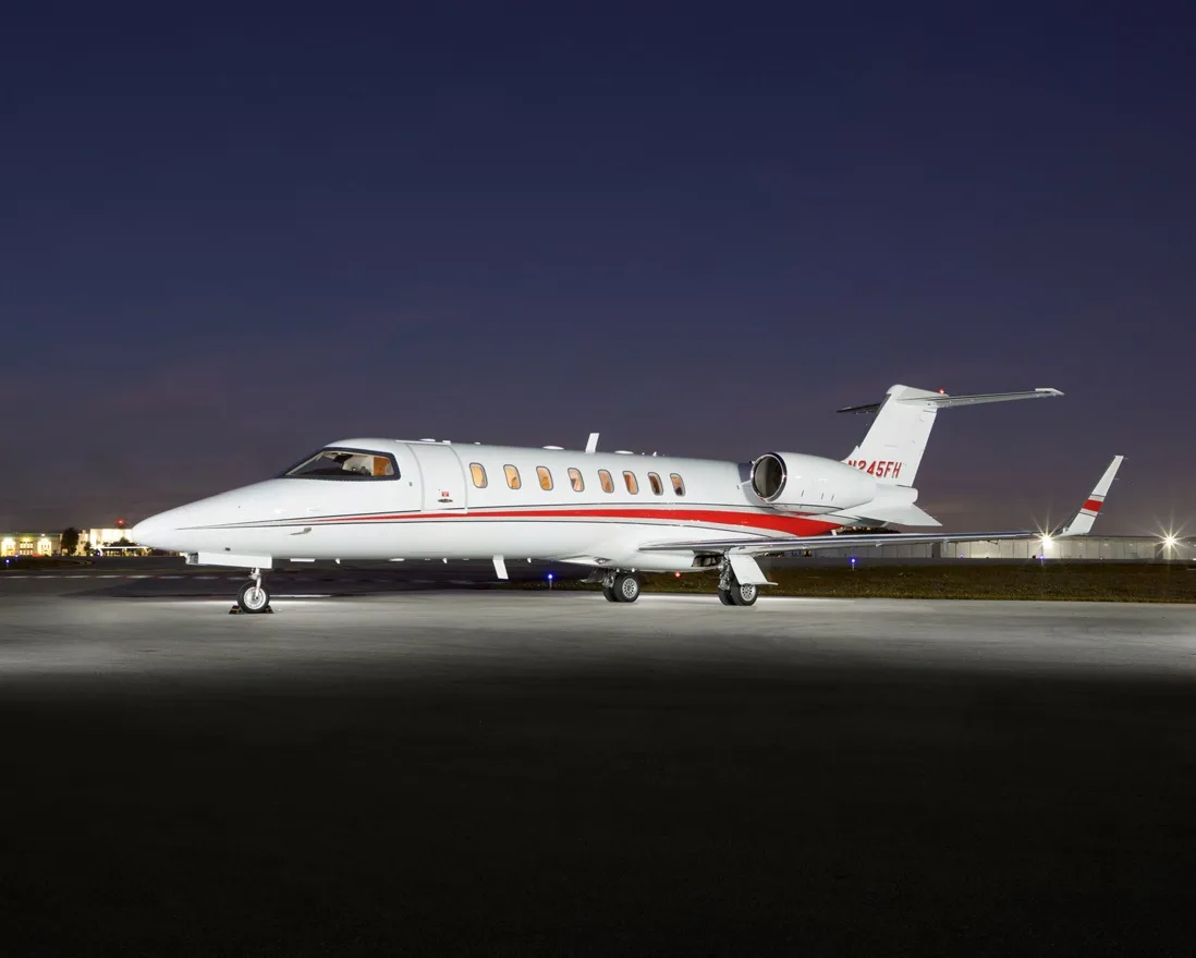 Learjet 45XR N245FH on the tarmac at night.