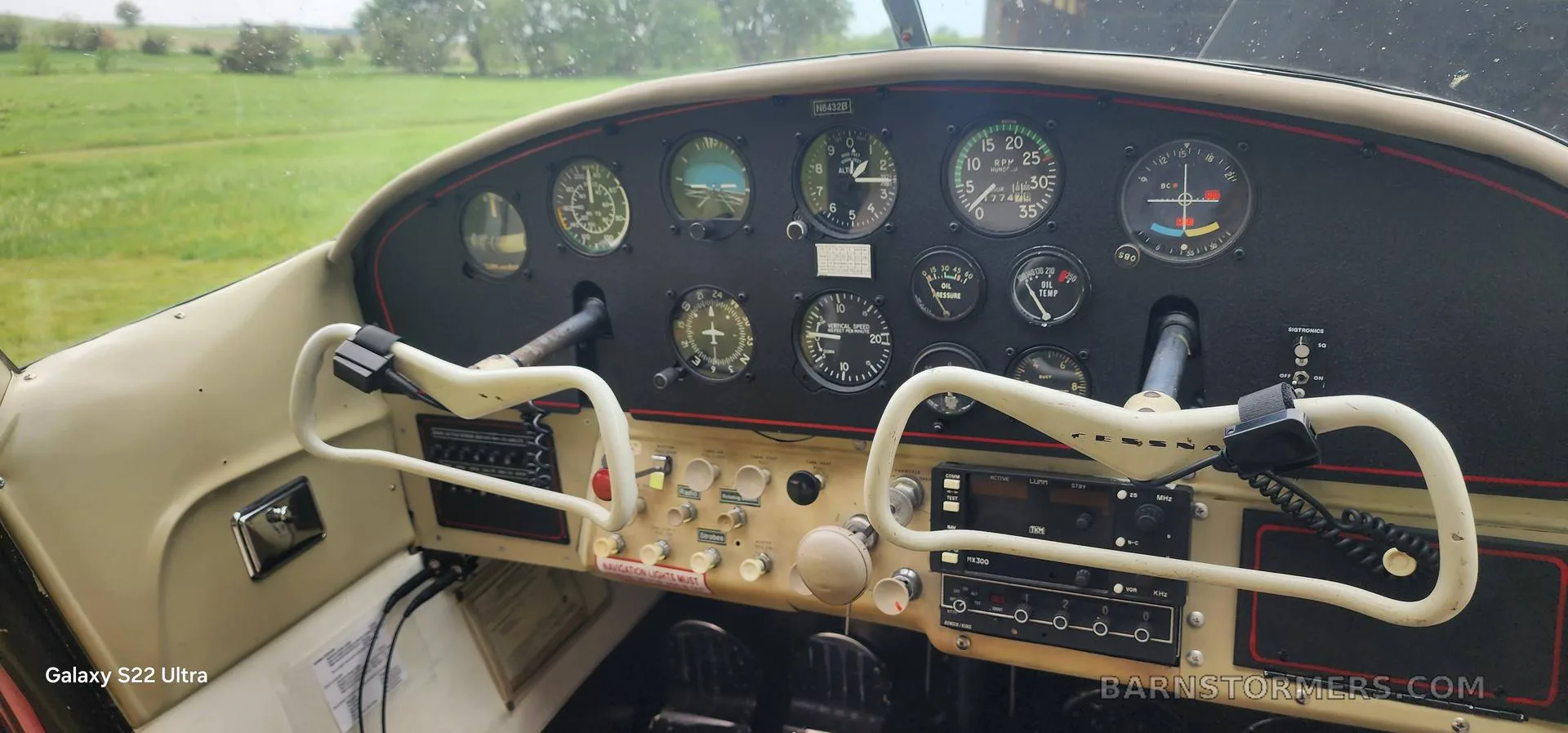 The instrument panel and yokes of a small aircraft, showing various gauges and avionics.