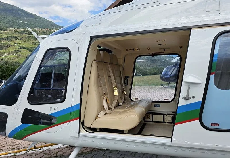 Interior view of the AgustaWestland AW109 helicopter cabin with beige leather seats.