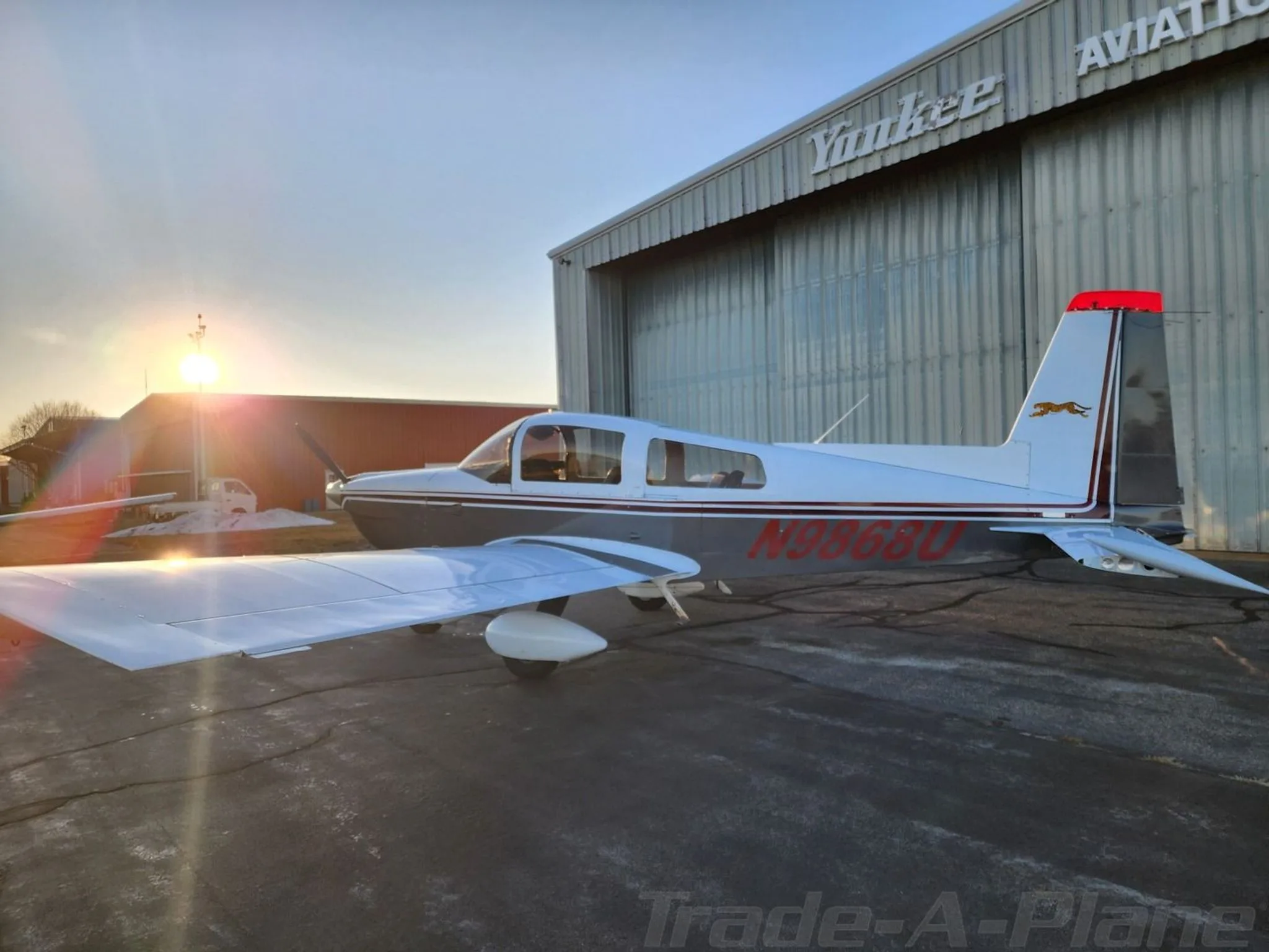 The aircraft with the sun setting in the background.