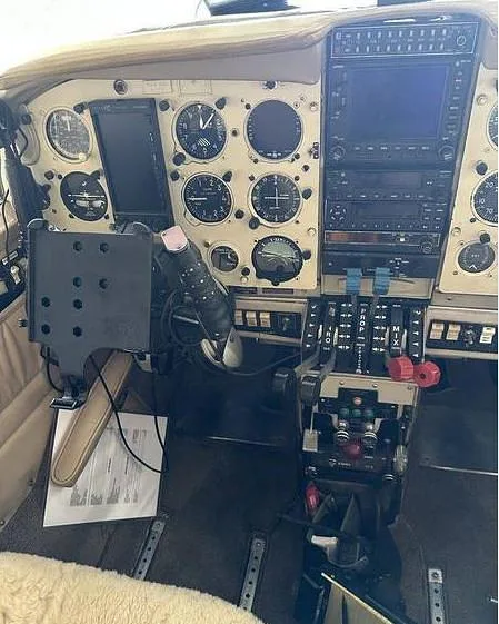 A detailed view of the aircraft's instrument panel with various gauges, screens, and controls.