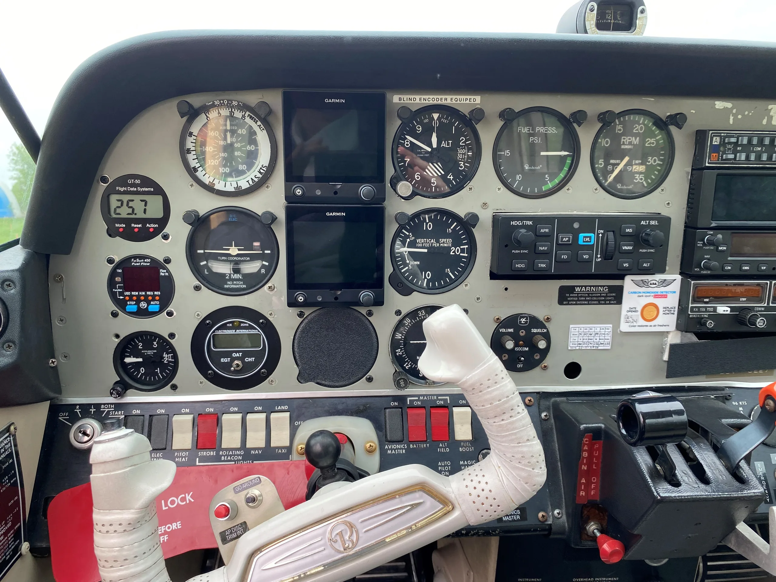 A close-up view of the pilot's side of the Sundowner C-23 instrument panel with various gauges and avionics.