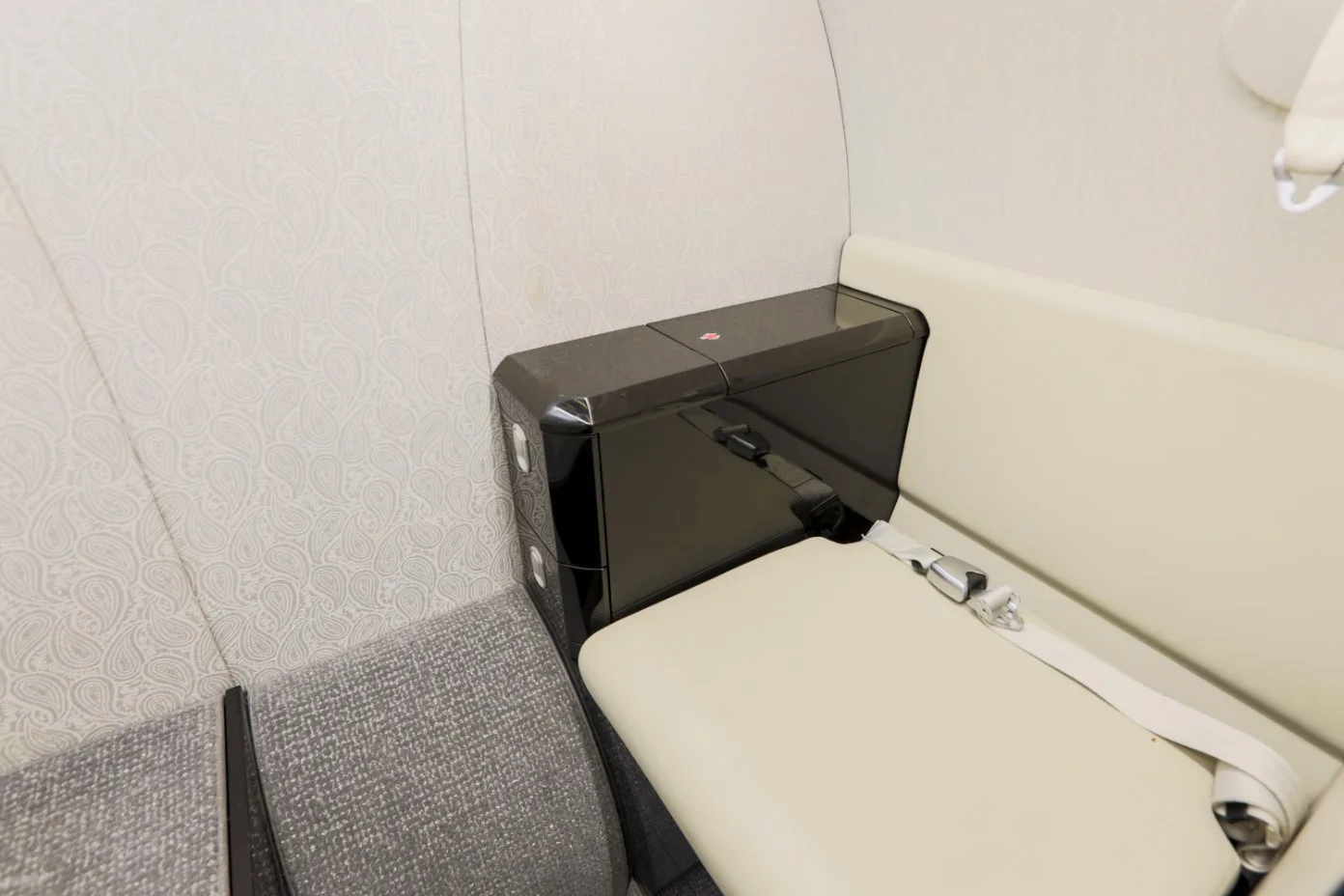 A close-up of the aircraft's interior, showing the seating and side table.