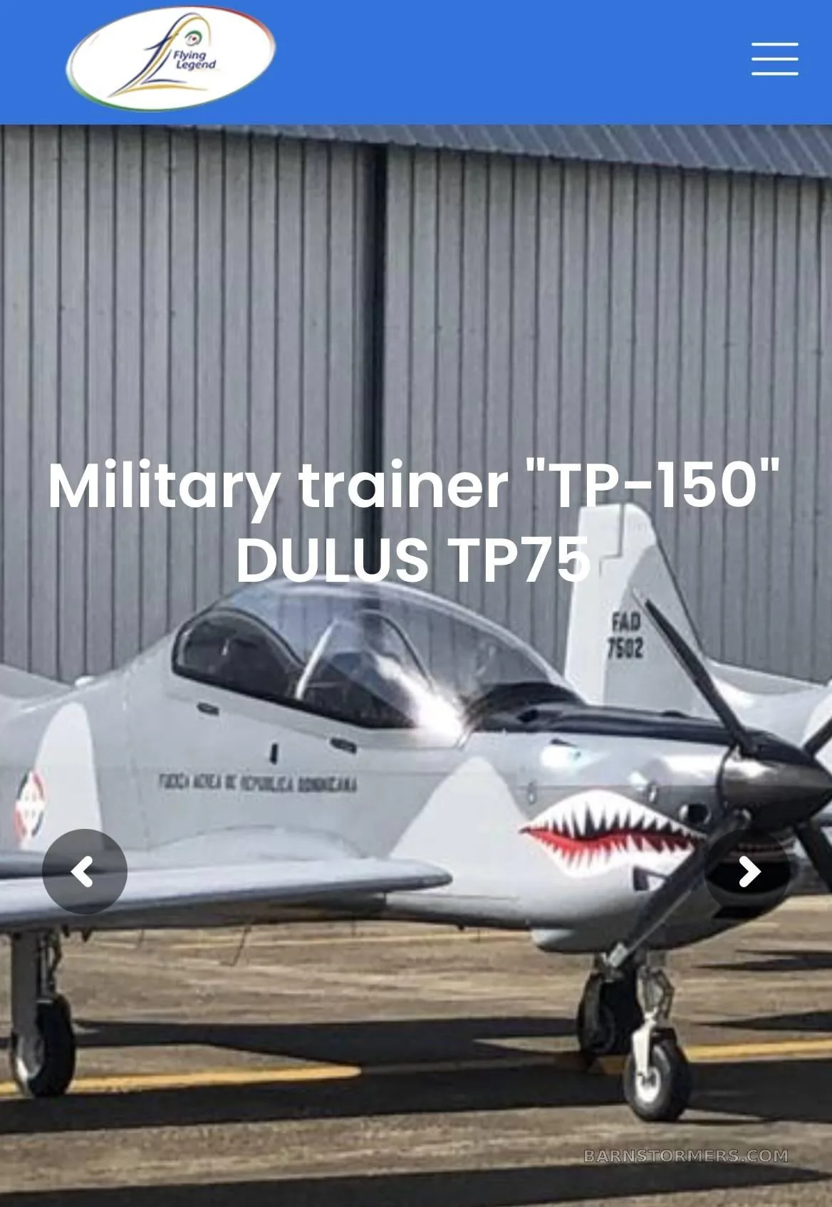 A DULUS TP75 military trainer aircraft in light gray camouflage with shark mouth nose art, parked on an tarmac.