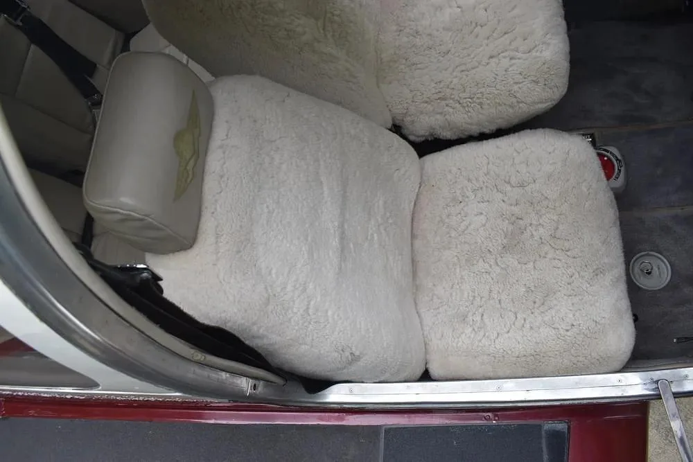 Close-up view of the aircraft's interior seats covered with white sheepskin.