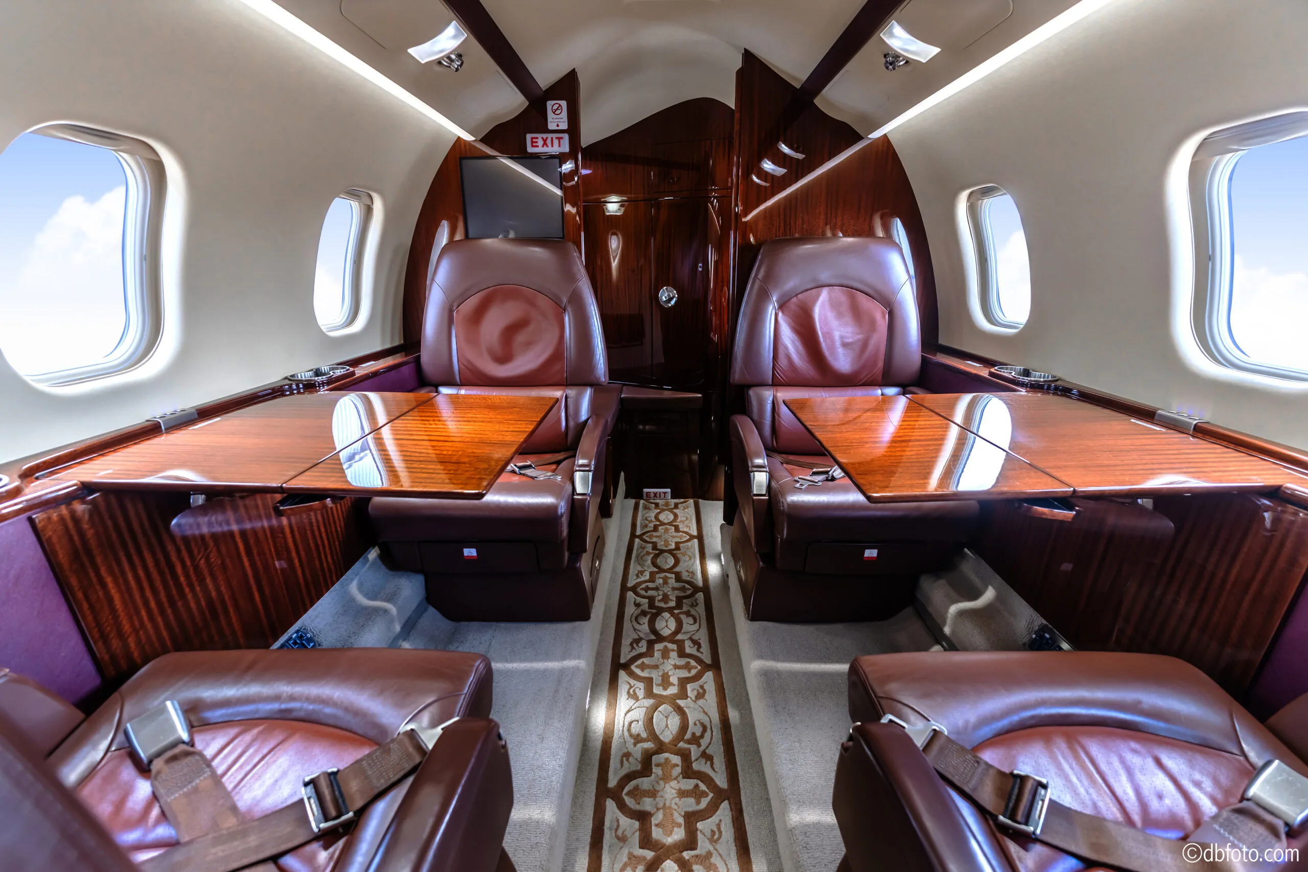 View of the Learjet 45XR cabin with leather seats and tables.