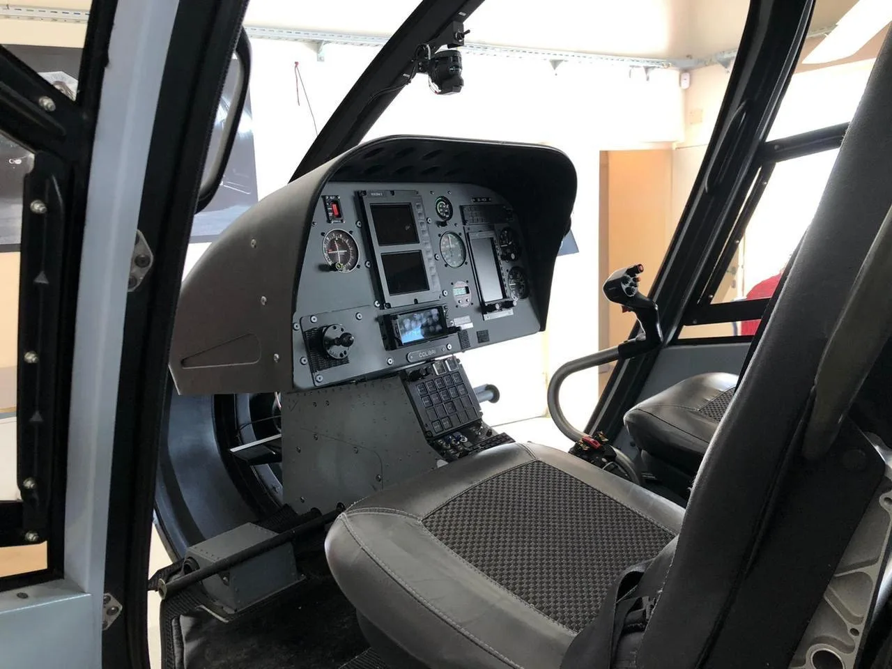 The cockpit of the helicopter features gray seats and a gray instrument panel.
