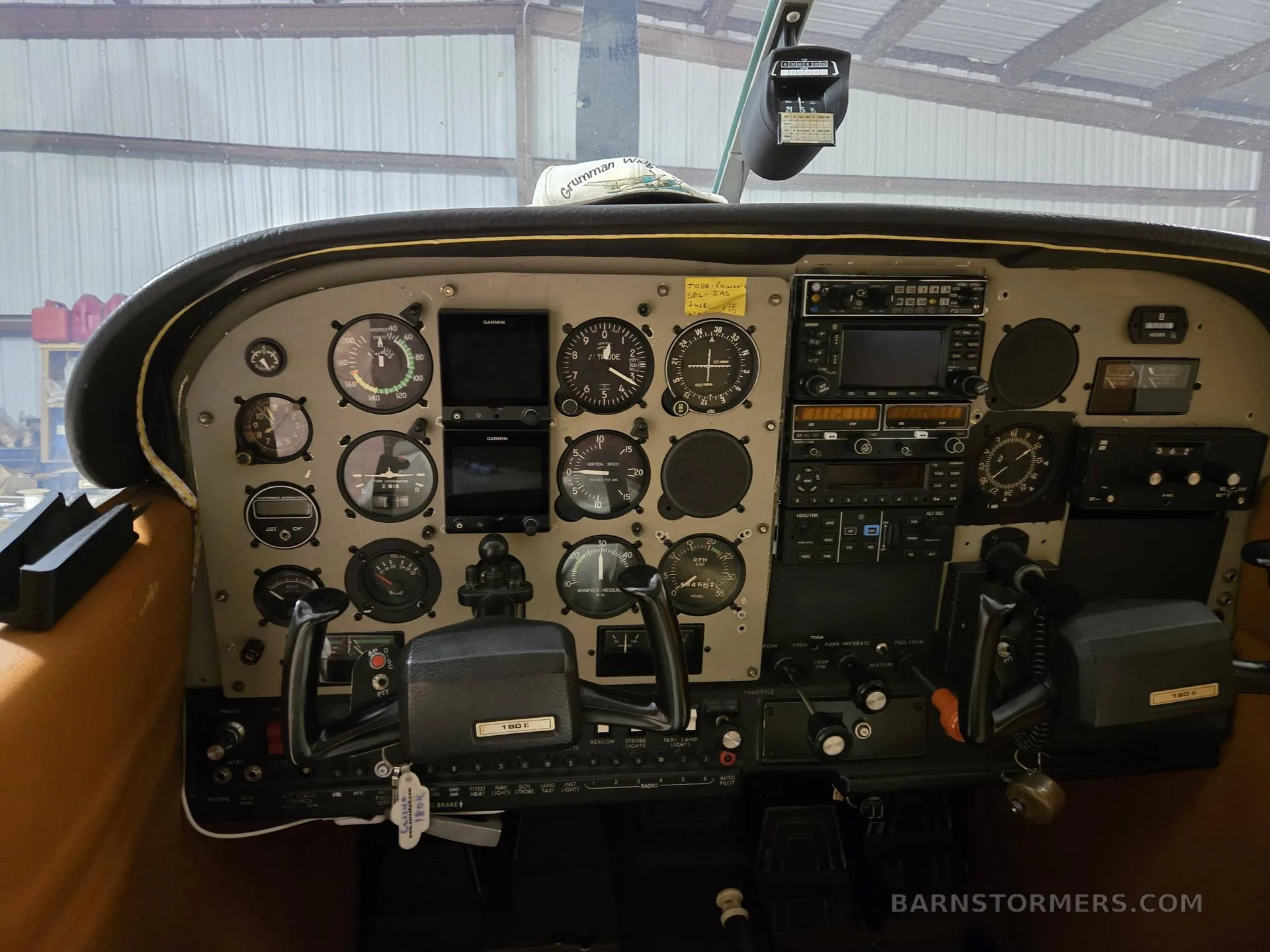 The cockpit instrument panel of a single-engine aircraft, showing a mix of analog gauges and digital displays.