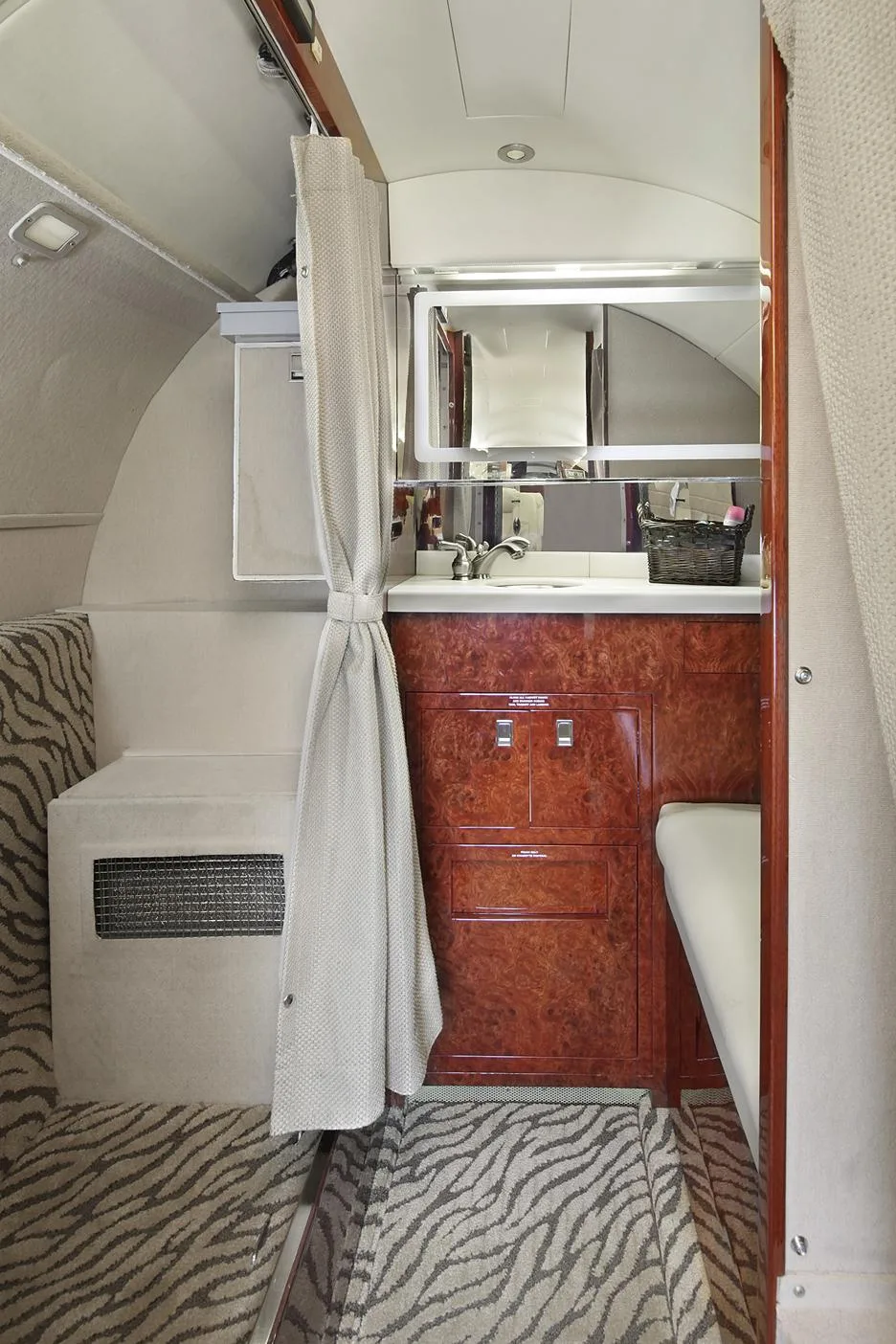 Aircraft lavatory with sink and storage.