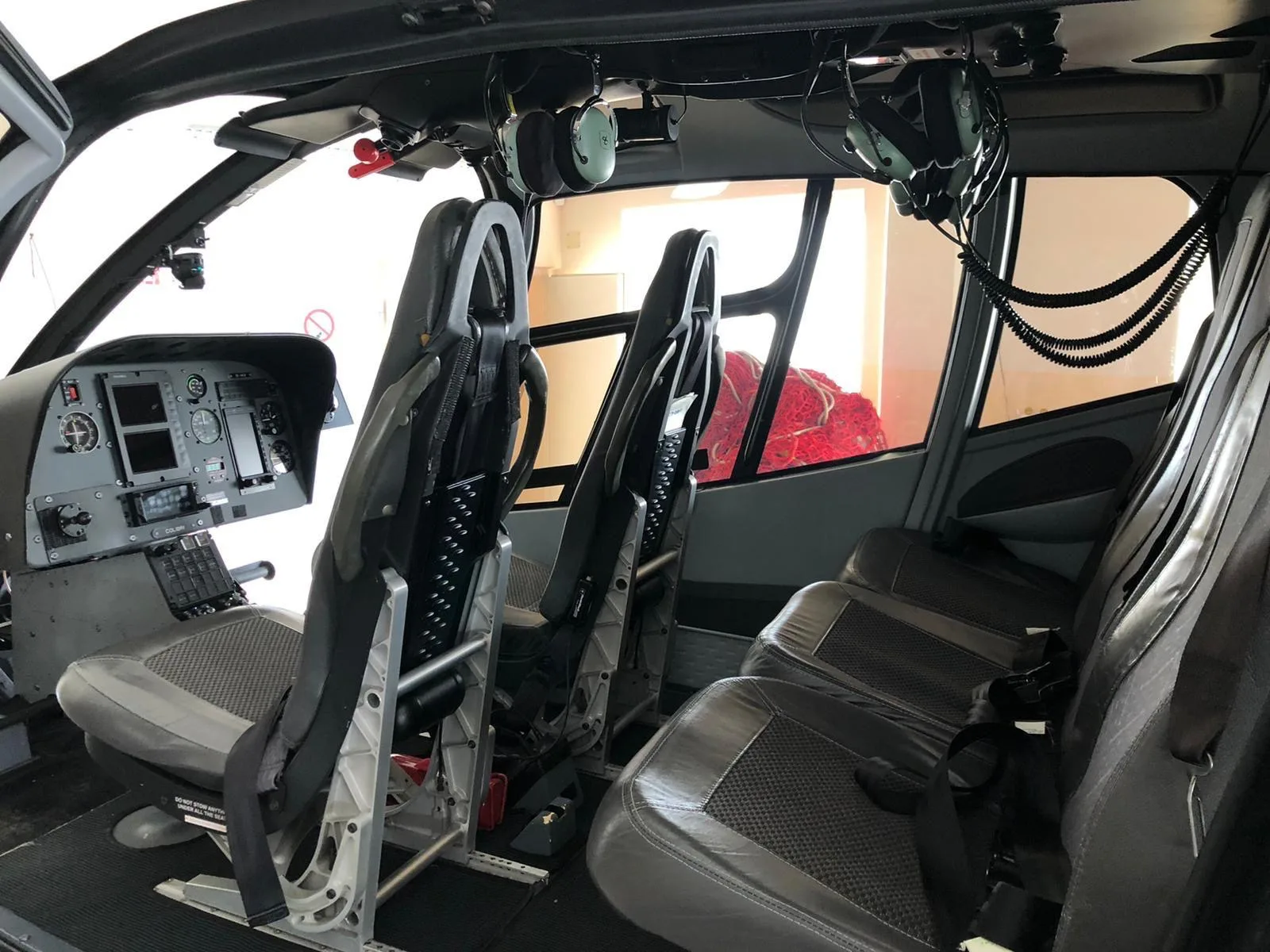 The interior of the helicopter has gray seats and black flooring.