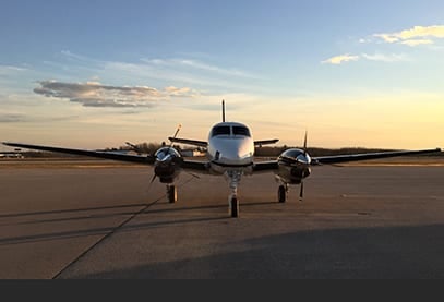 Front view of a Beechcraft King Air on the tarmac.