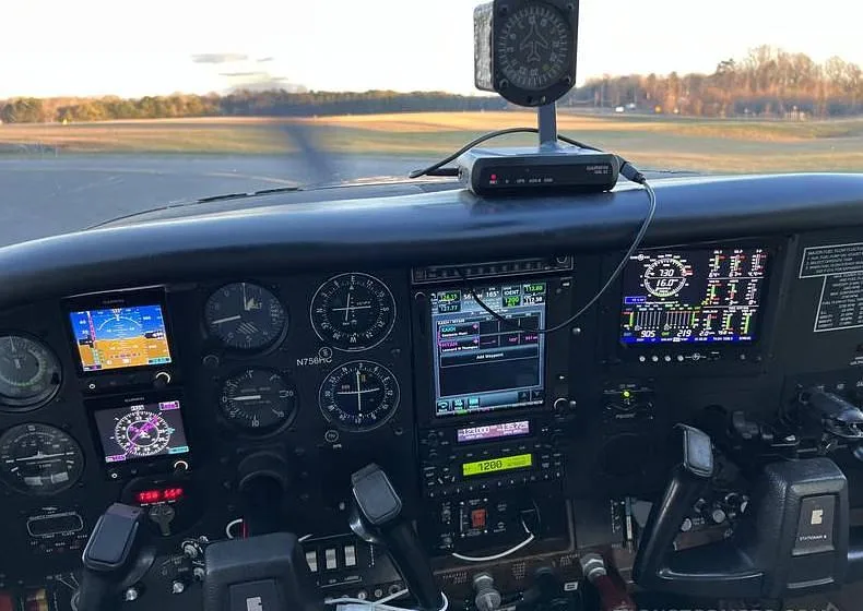 The cockpit of the Cessna 182, N756HC, featuring a modern glass panel with multiple digital displays and traditional gauges.