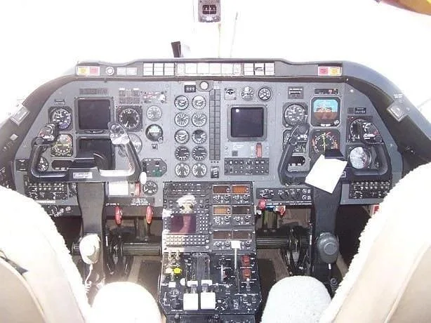 A full view of the aircraft's cockpit instrument panel, featuring multiple gauges and screens.