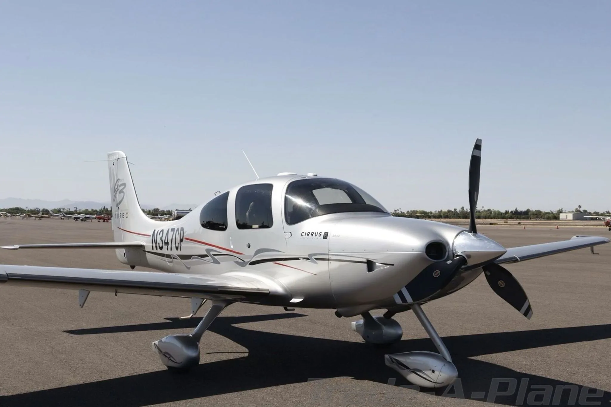 A front three-quarter view of the silver Cirrus SR22 GTS Generation Three Turbo aircraft, registration N347CP, on an airport tarmac.